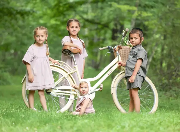 Siblings with a white bicycle in a park, outdoor photography by Photoholic, Rockland County NY
